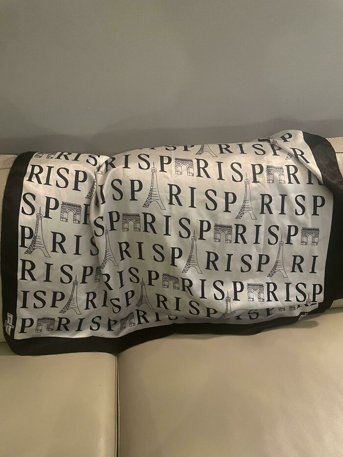 A pillow with the word PARIS and Eiffel Tower repeated, an awful design fail with a spelling error.