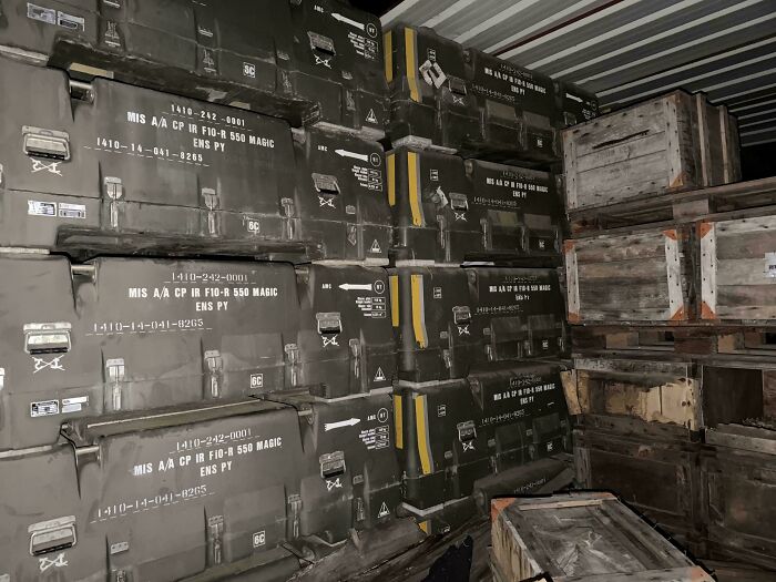 Urban explorers discovered a room full of stacked green military crates and wooden boxes.