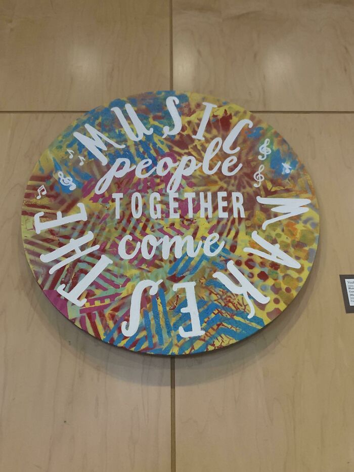 A circular art piece with a confusing arrangement of words, a design fail that is hard to read.