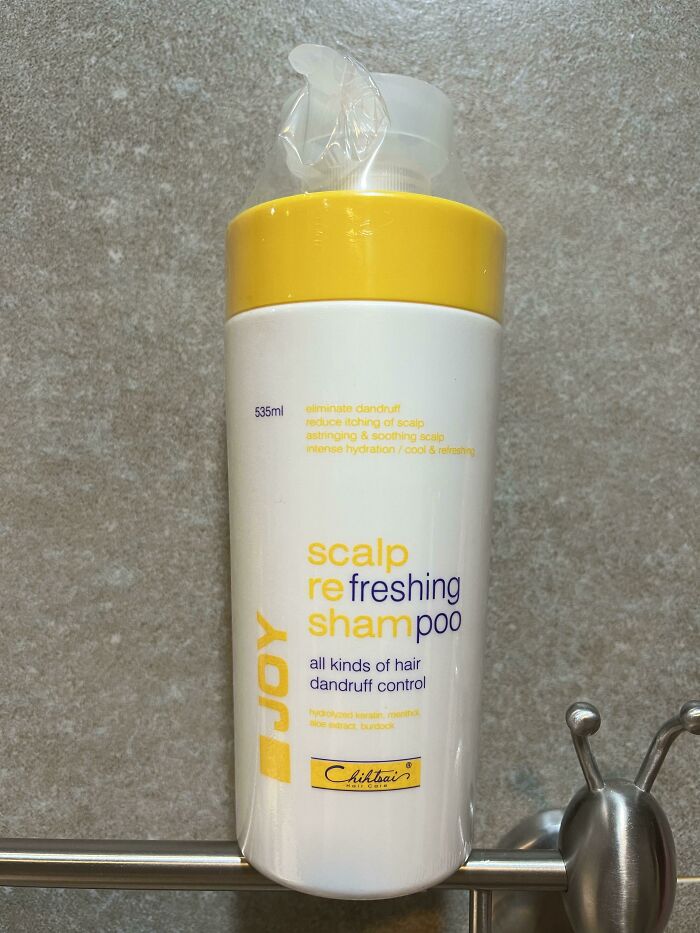 A shampoo bottle with confusing and poorly formatted text, showcasing a design fail.
