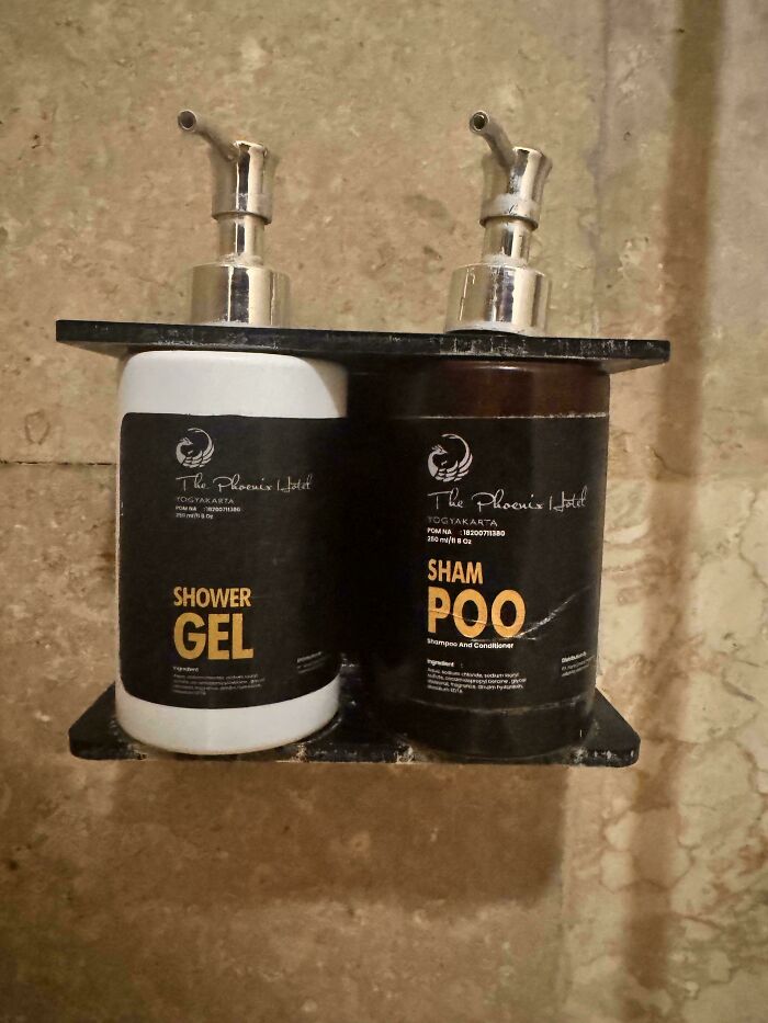 A hotel shower with two bottles labeled shower gel and sham p*o, a hilarious design fail.