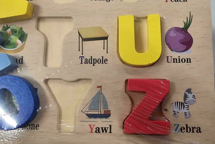 A hilariously awful design fail: an alphabet puzzle with incorrect or oddly chosen words for letters, like 'Union' for U.