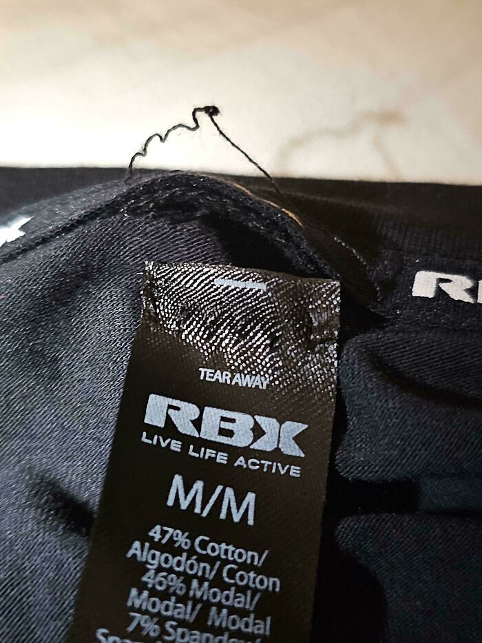 A clothing tag marked M/M for size, an awful design fail.