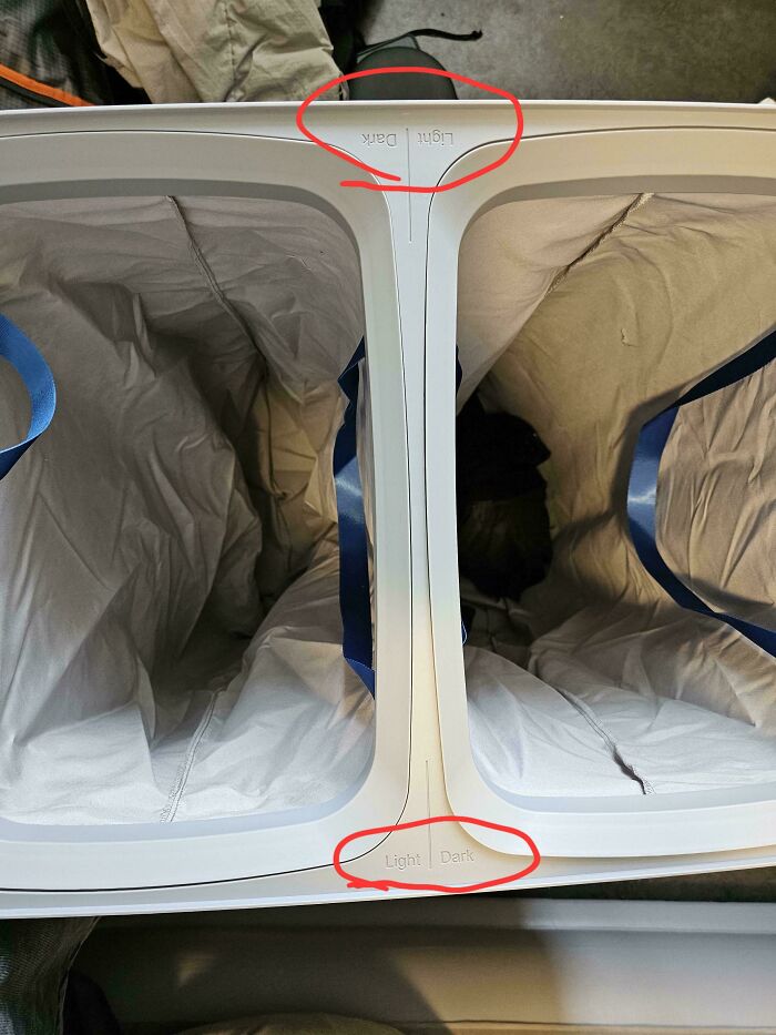 A laundry sorter with reversed labels, dark over light and light over dark. A design fail.