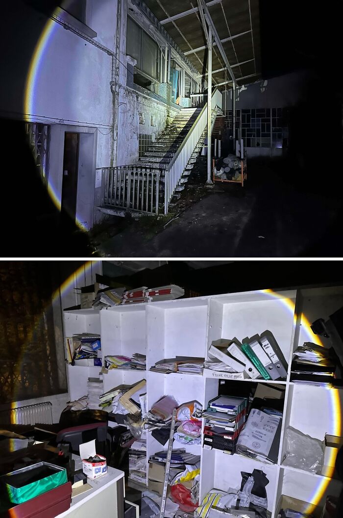 Urban explorers discovered an abandoned building at night, revealing a cluttered office with shelves full of old files.