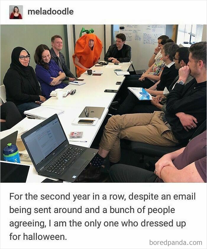 A person in a carrot costume at a meeting, the only one dressed for Halloween, creating internet chaos.