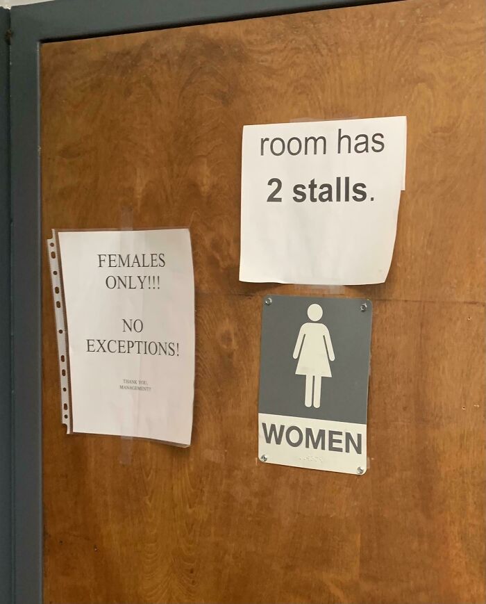 Photos of the USA: a wooden door with multiple handwritten signs, including one that says room has 2 stalls and another that reads FEMALES ONLY!!! NO EXCEPTIONS!