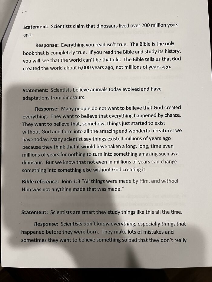 Photos of the USA: A printed page with statements and responses about scientific claims versus biblical interpretations.