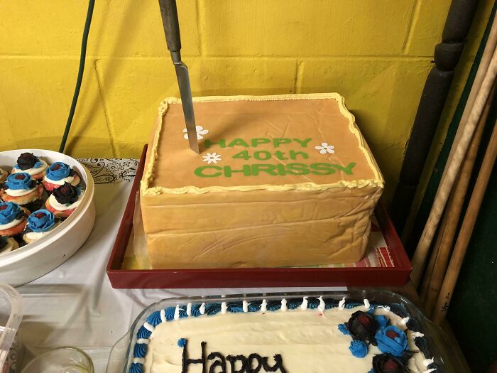 Photos of the USA: A square birthday cake with green icing that reads Happy 40th Chrissy and a knife stuck in it.