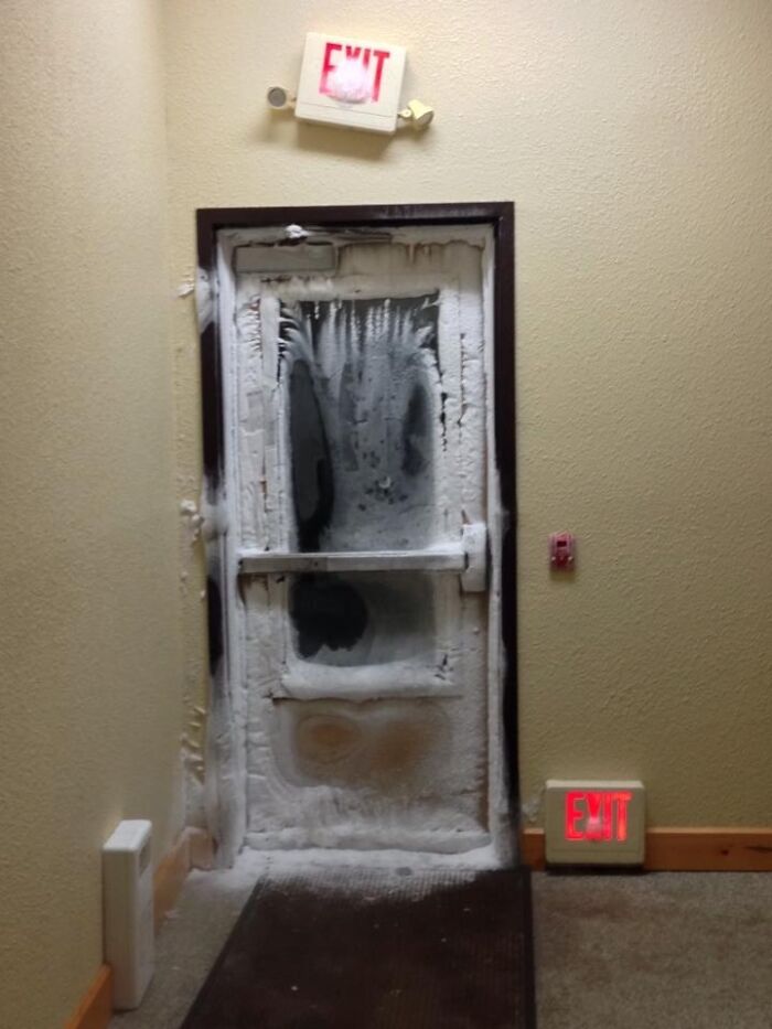 An exit door heavily frosted over, displaying the varied climate in photos of the USA.