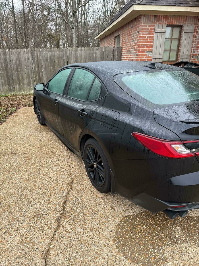 A black car on a wet driveway, showcasing different photos of the USA.