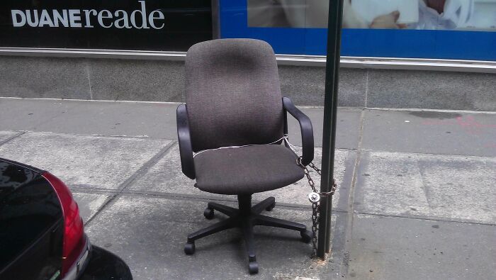 An office chair chained to a pole on a city sidewalk, an unusual sight among the wildly different photos of the USA.