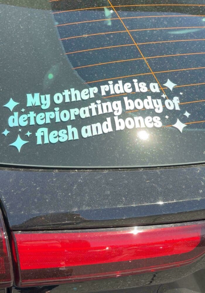 Wild bumper sticker on a car window reading My other ride is a deteriorating body of flesh and bones with sparkles.