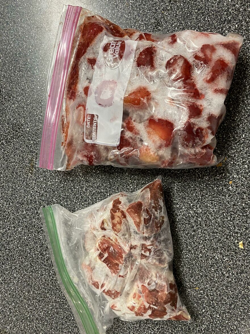 Two bags of mildly amusing frozen fruit, one with strawberries and the other with mixed fruit.