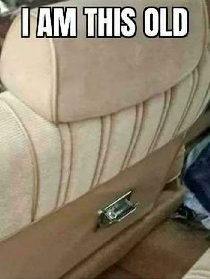 A car seatbelt buckle from an older car model with the text I AM THIS OLD, one of the ancient memes.