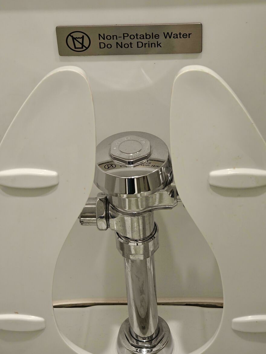 A sign above a toilet that reads, Non-Potable Water Do Not Drink, an amusing thing to see.