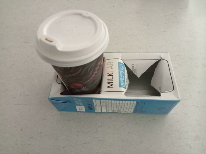 A genius business idea: coffee cup with milk carton used as a carrier.