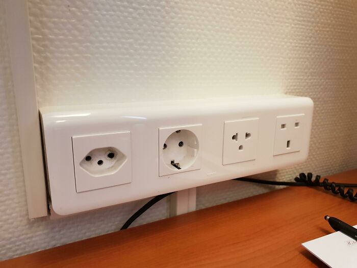 A surprisingly simple and genius idea, a multi-outlet power strip with various international sockets on a desk.