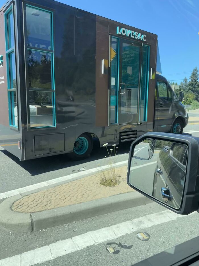 A Lovesac mobile showroom truck with turquoise windows and a brown exterior, a simple solution to retail problems.