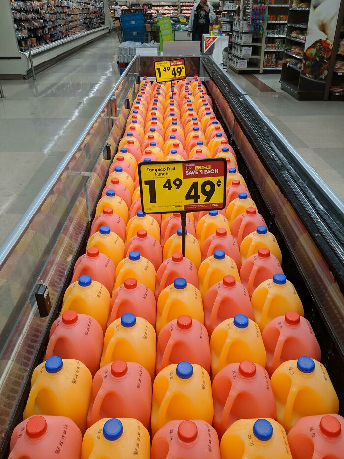 A supermarket aisle filled with Tampico Fruit Punch bottles, a simple, genius idea for product display.