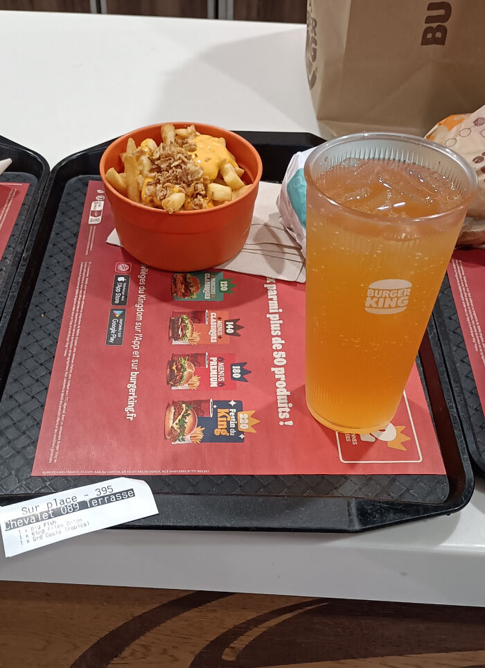 Burger King meal with fries and an orange drink on a tray, a business solving everyday hunger.