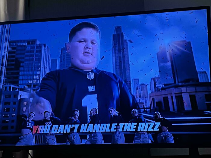 A large man in a sports jersey on a TV screen with the text You Cant Handle The Rizz, part of annoying commercials.