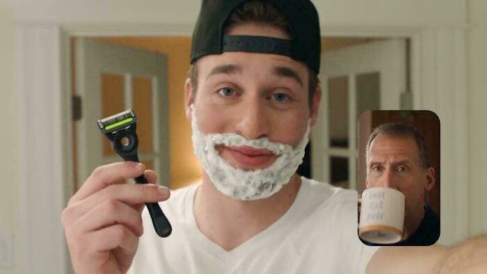 A man with a shaving cream beard holding a razor, with another man drinking coffee in an inset, depicting a commercial.