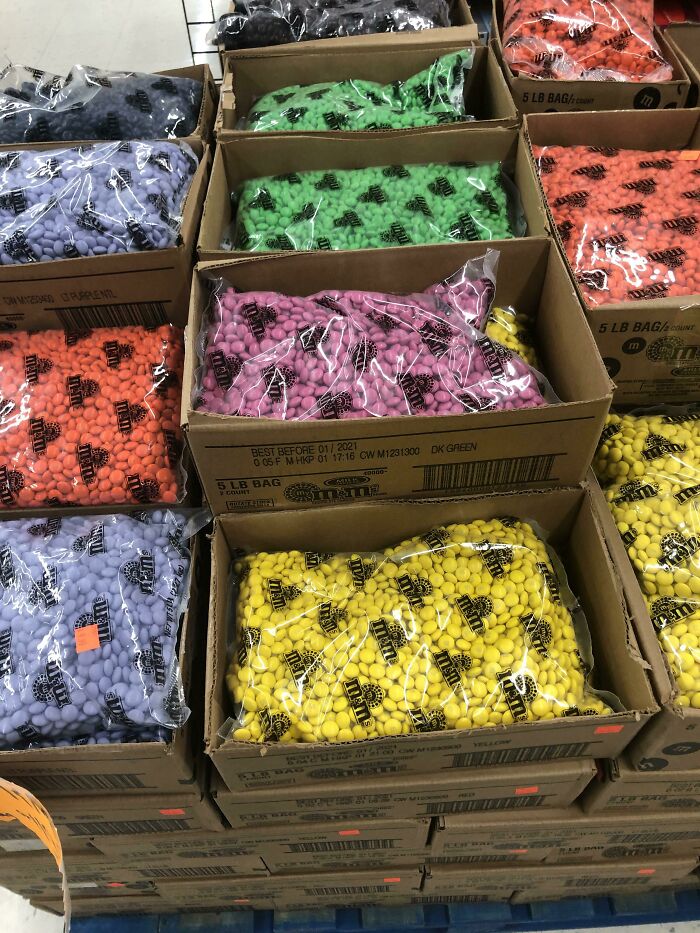 Giant boxes of colorful M&Ms, illustrating a surprisingly simple and genius idea for bulk candy sales.