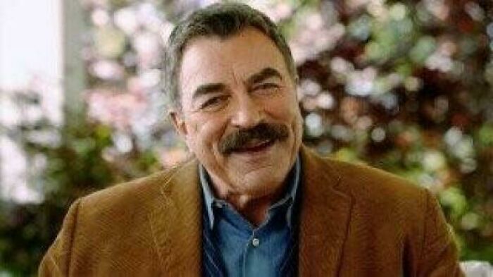 Close-up of Tom Selleck smiling, featured in various commercials.