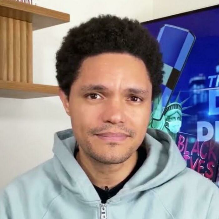 Trevor Noah, host of The Daily Show, appears in a commercial people cant stand, serious in a light hoodie.
