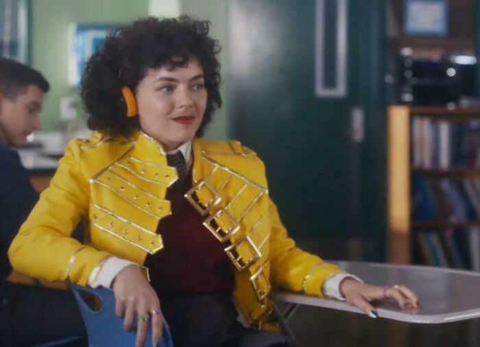 A person in a yellow jacket and headphones, from a list of commercials people can't stand.