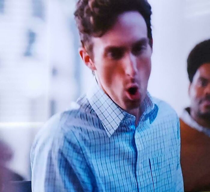 A man in a blue plaid shirt with an open mouth, part of a commercial people cant stand with their whole heart.