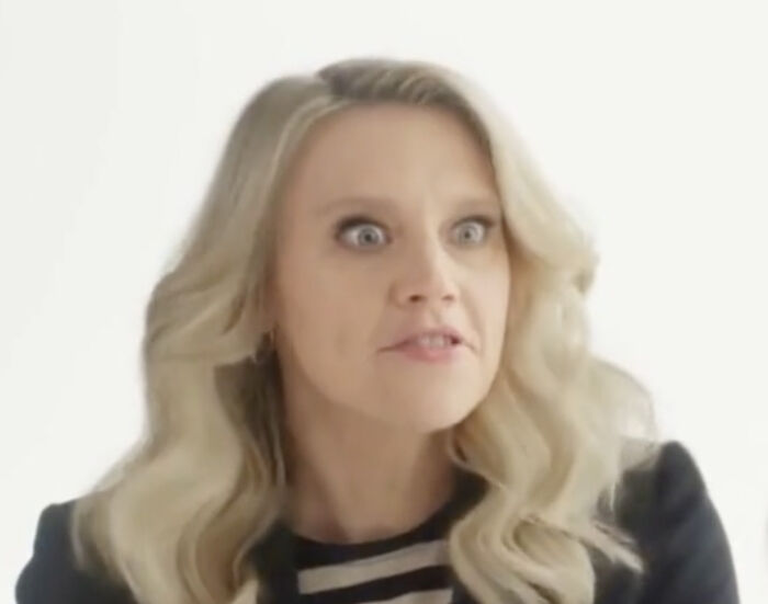 A woman with long blonde hair and wide eyes shows a startled expression, a common sight in commercials designed to grab attention.