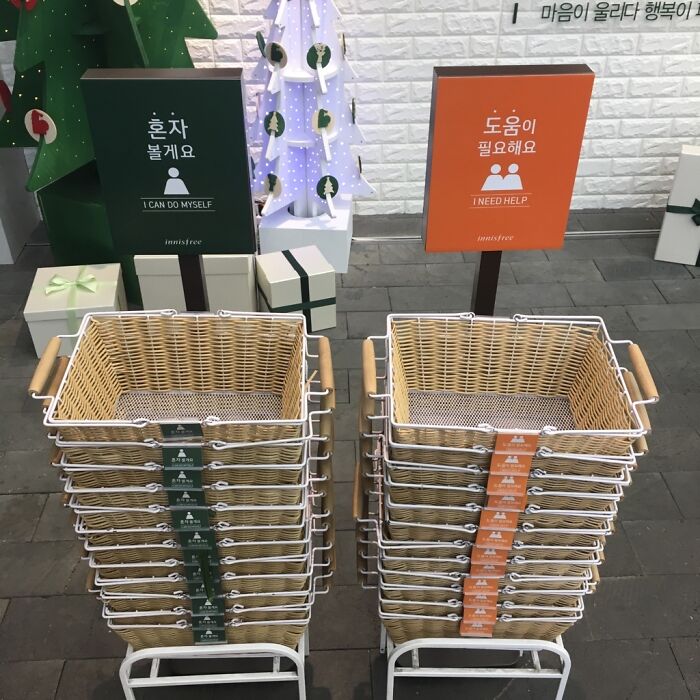Green and orange signs above two stacks of shopping baskets, solving everyday problems with genius ideas.