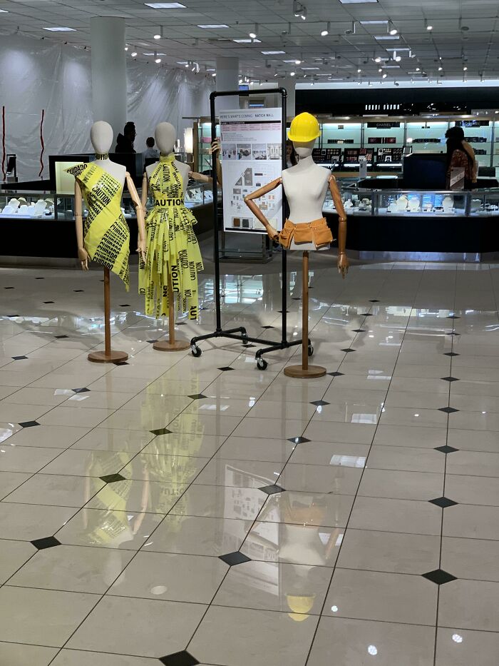 Mannequins dressed in caution tape clothing, showcasing a surprisingly simple and genius fashion idea.