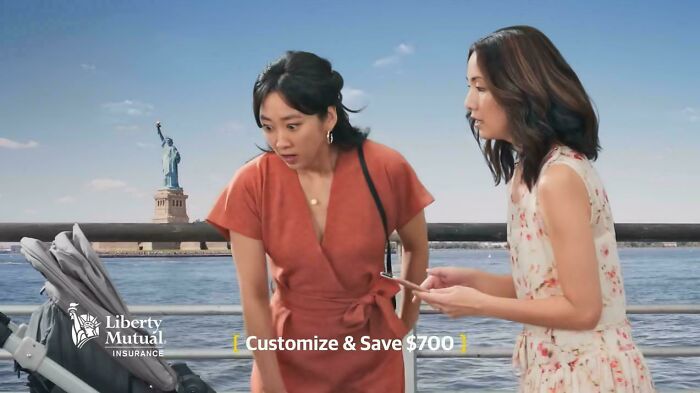 Two women by the Statue of Liberty, surprised, in a Liberty Mutual commercial people can't stand.