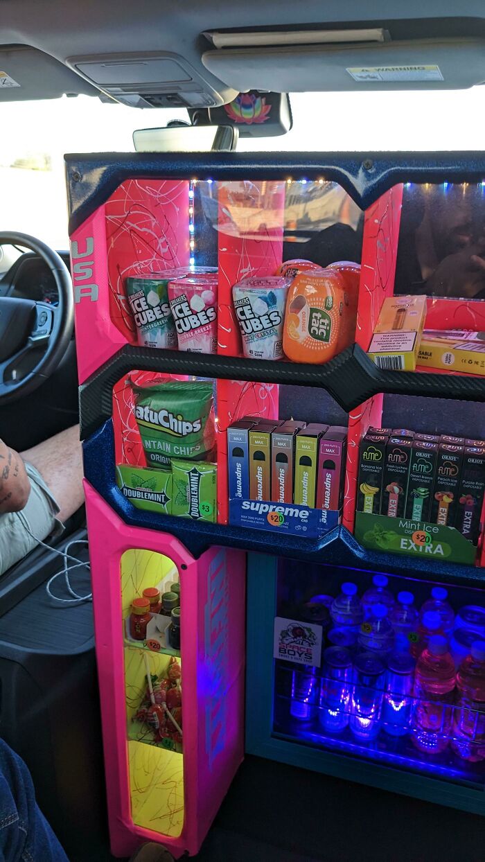 A custom car interior with a built-in snack and drink display, a genius business idea for convenience.