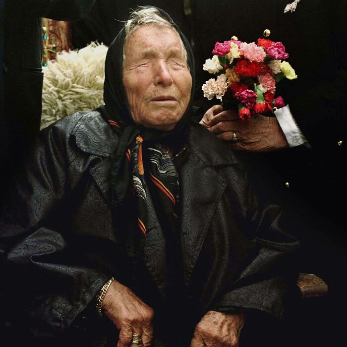 A woman who predicted 9/11 is seen, a person gives her flowers, she looks as if her eyes are closed or are not there.
