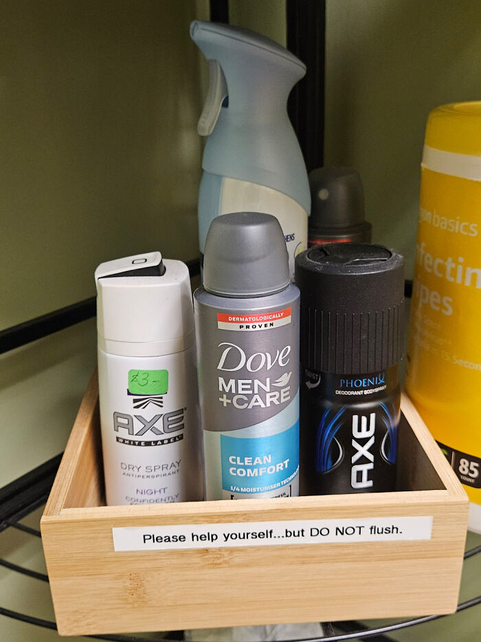 A wooden box containing various deodorants and body sprays for customer use, solving an everyday problem.
