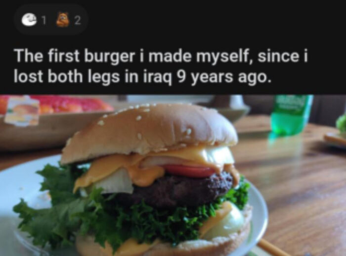 A burger with lettuce, cheese, onion, and tomato on a sesame seed bun, made by someone who shared unhinged things.