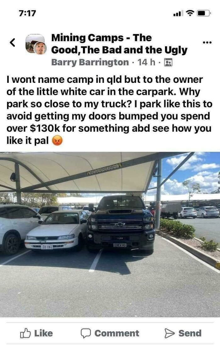A black truck parked extremely close to a white car, highlighting people who think they're the main character.