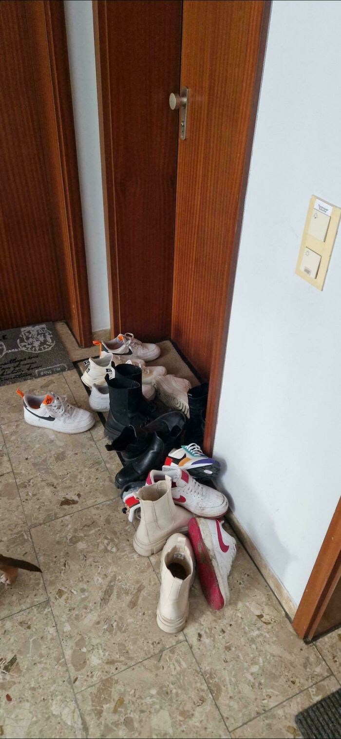A pile of shoes by a doorway, a classic example of someone acting like the main character.