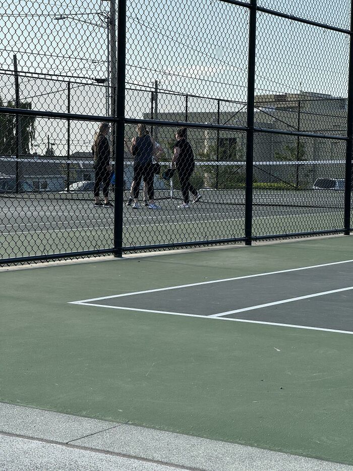 Three people on a pickleball court, showing a scenario of people who think they are the main character.