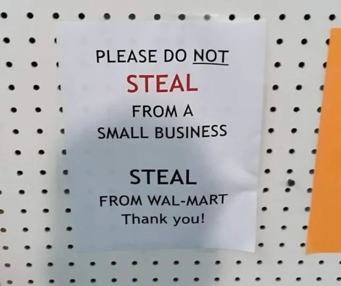 A sign on a pegboard advising not to steal from small businesses but to steal from Walmart, a blursed meme.