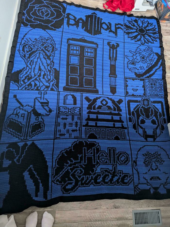 Blue and black crochet blanket featuring Doctor Who themed designs and text