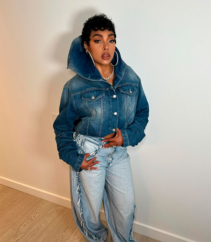 Taraji P. Henson posing in a denim jacket and distressed jeans, showcasing her appearance.