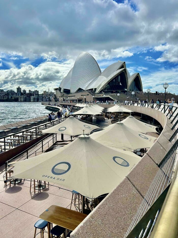 The Sydney Opera House and Opera Bar, an iconic example of modern architecture design by the water.