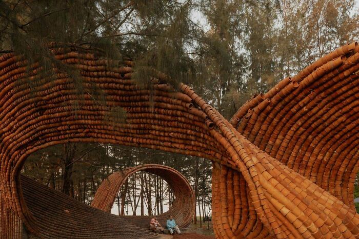 Amazing and beautiful modern architecture designs showcase an organic-looking structure made of terracotta pipes, blending with nature.