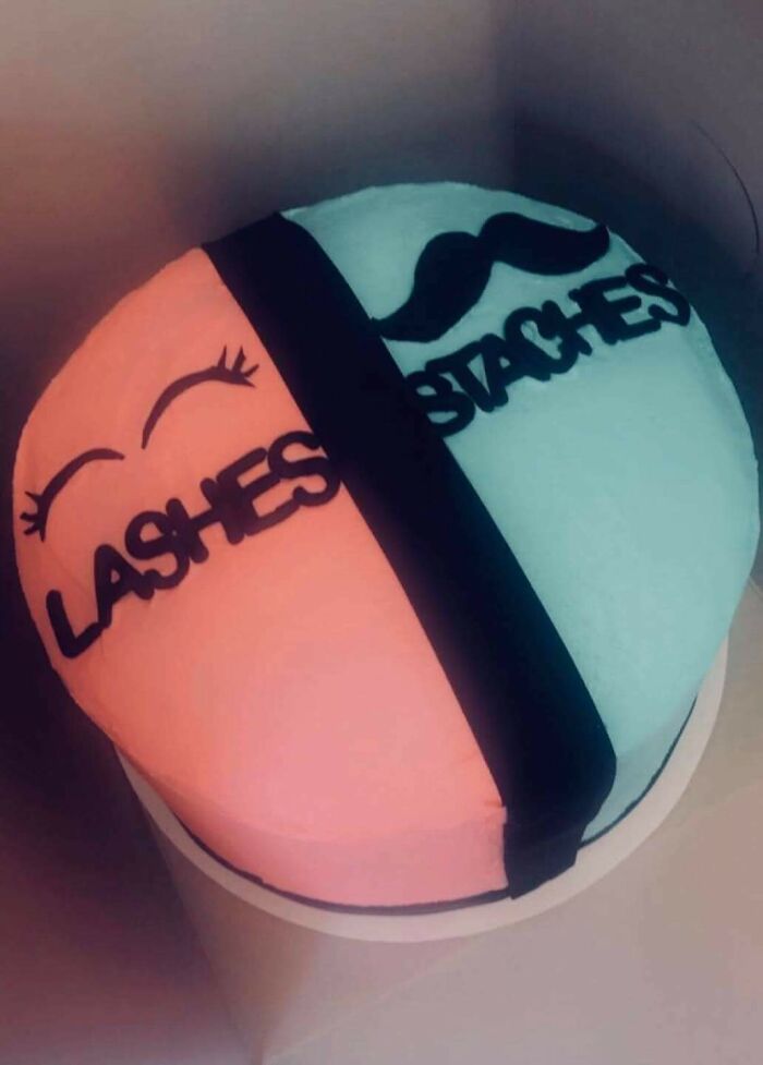 A gender reveal cake split pink and blue with text Lashes and Staches, highlighting gender reveal moments.