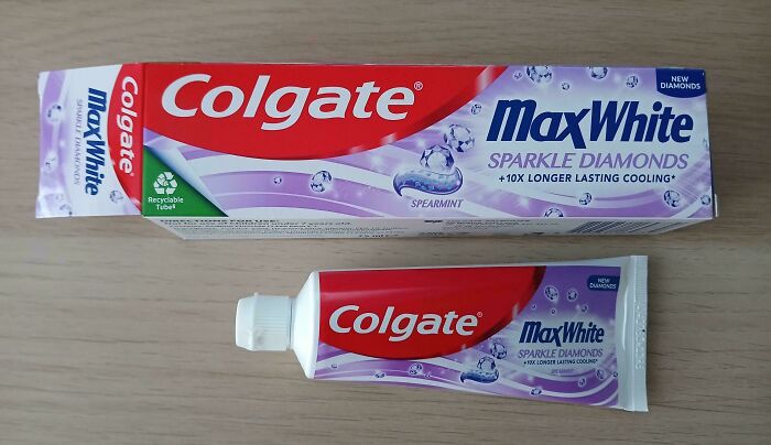 Colgate MaxWhite toothpaste box much larger than the actual tube, showcasing misleading marketing practices.